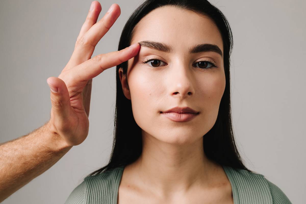 Person undergoing blepharoplasty to remove excess eyelid skin and reduce droopy lids